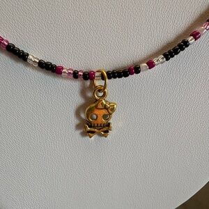 Hand beaded necklace with “girl skull” charm